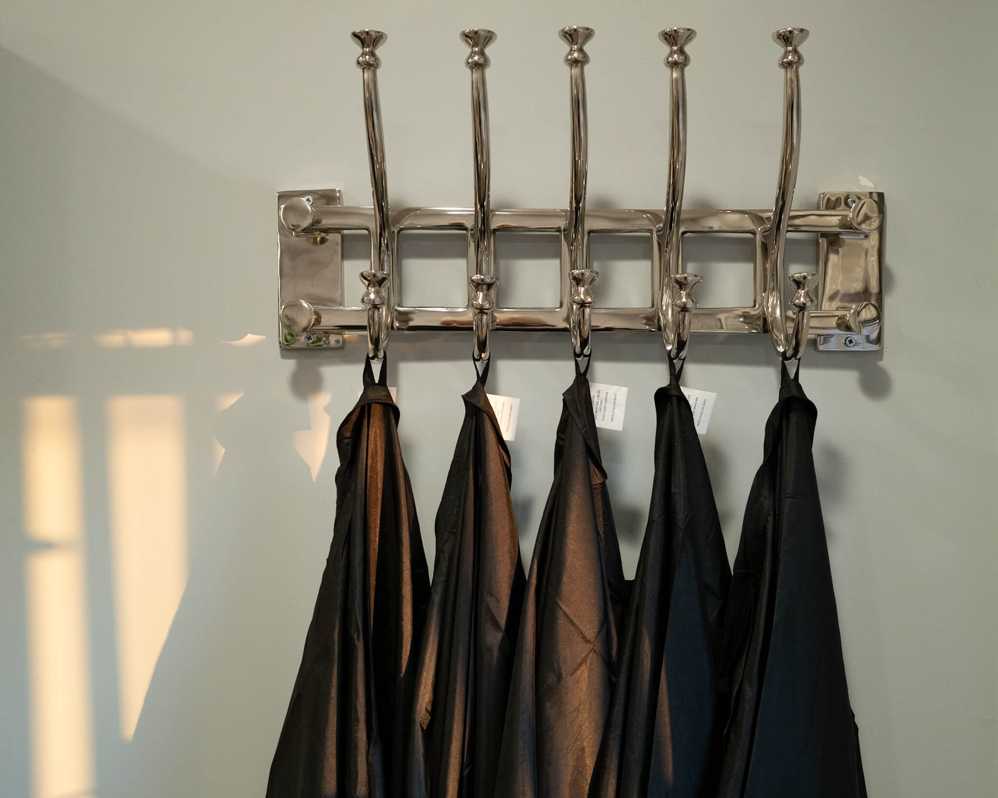 Hairdressing gowns hanging on a rack