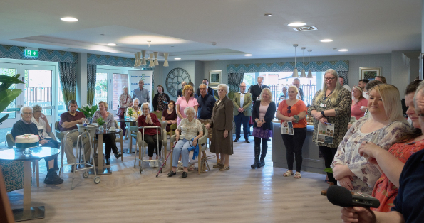 A group shot of everyone who is listen to a speech.