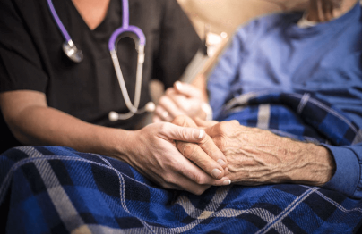 A nurse sits with a resident