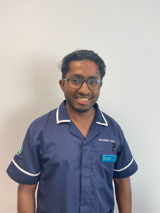 man with glasses smiling for staff photo