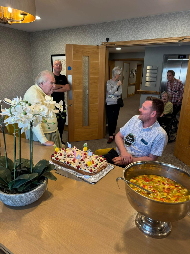 home manager chatting to residents on his birthday