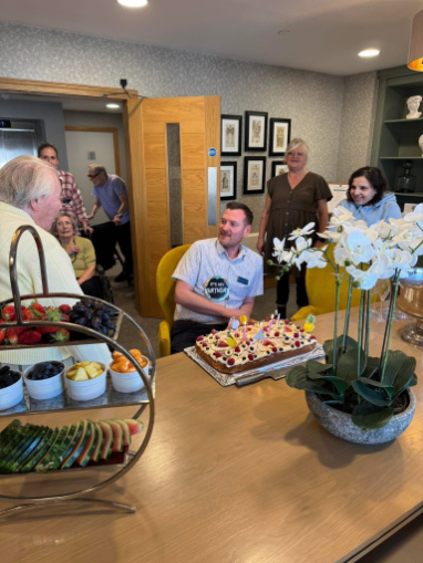 home manager on his birthday chatting to residents