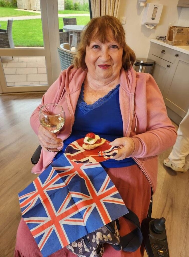 one of our residents enjoying afternoon tea on VE day
