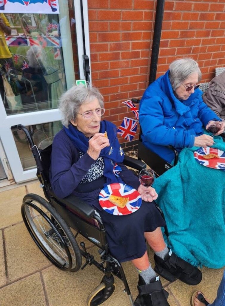 residents sat outside enjoying afternoon tea