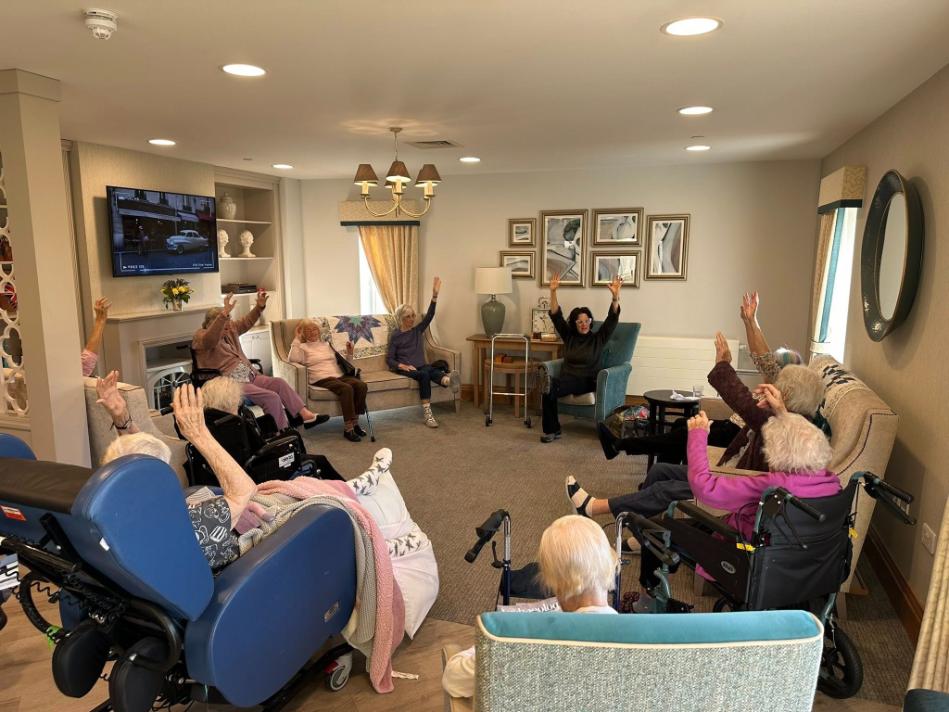 older adults sat doing yoga