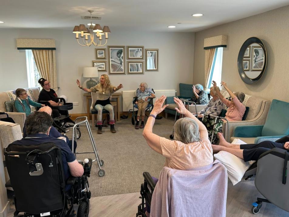 older adults sat doing yoga