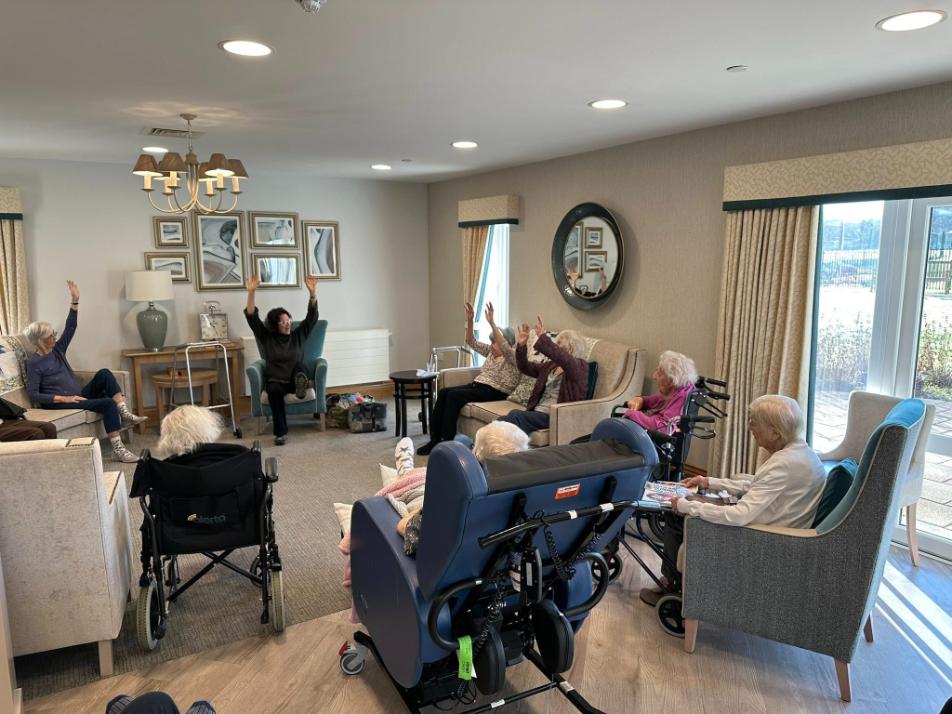 older adults sat doing yoga
