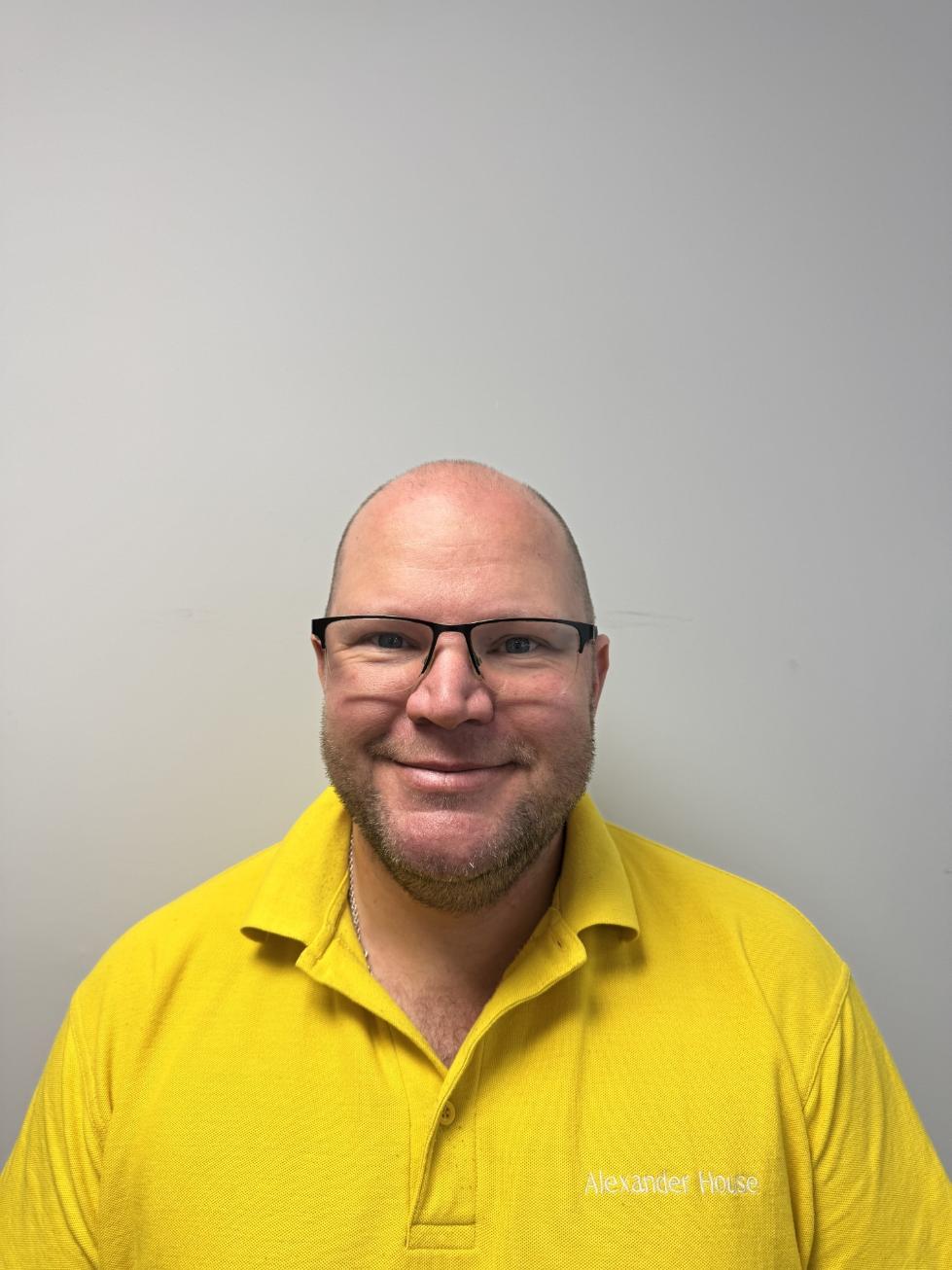man with glasses in yellow shirt and glasses