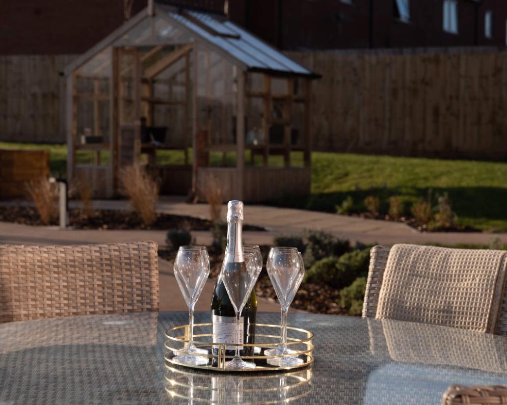 outdoor garden table with wine glasses on it