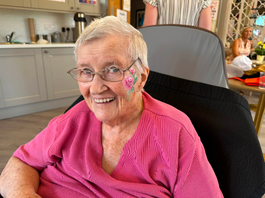 lady with pink jumper smiling