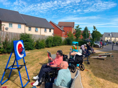 Residents chatting in the sunshine in the private garden at Alexander House